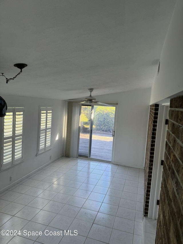 tiled empty room with ceiling fan