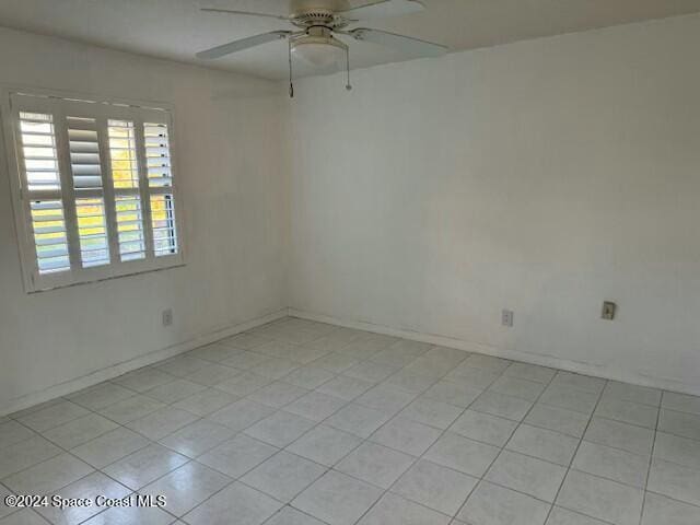 tiled empty room with ceiling fan