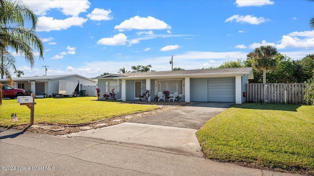 ranch-style house featuring a front lawn and a garage