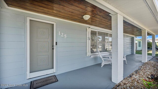 doorway to property featuring covered porch