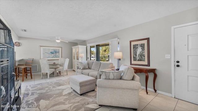 tiled living room with a textured ceiling and ceiling fan