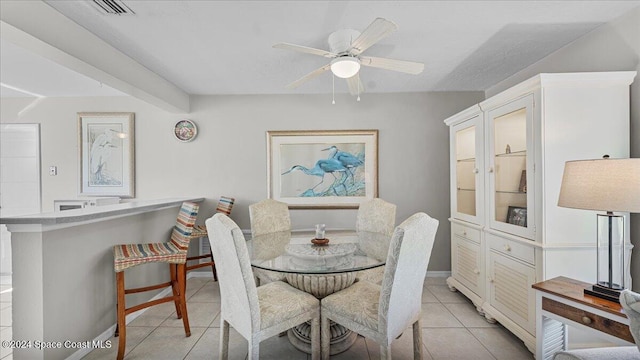 dining space with light tile patterned floors and ceiling fan