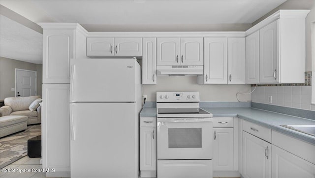 kitchen with white appliances, backsplash, white cabinets, sink, and light tile patterned flooring