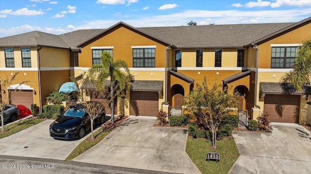 multi unit property featuring a garage