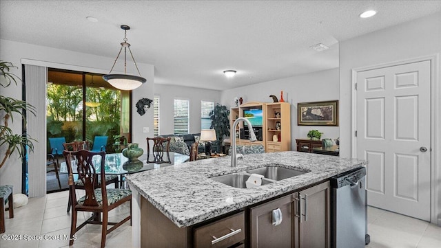 kitchen with a center island with sink, dishwasher, a healthy amount of sunlight, and sink