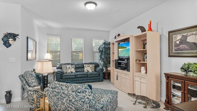 tiled living room featuring a textured ceiling