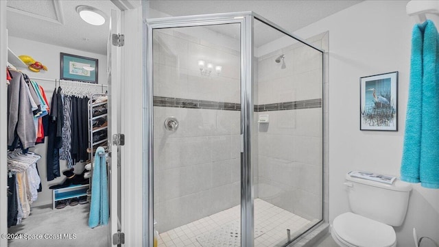 bathroom with toilet, a textured ceiling, and walk in shower