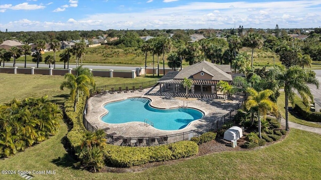 view of swimming pool with a yard and a patio