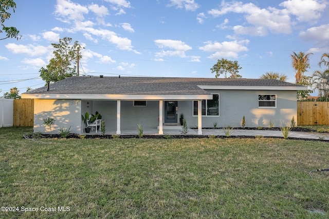 rear view of house with a yard