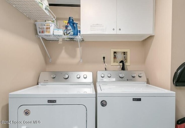 laundry area with cabinets and separate washer and dryer