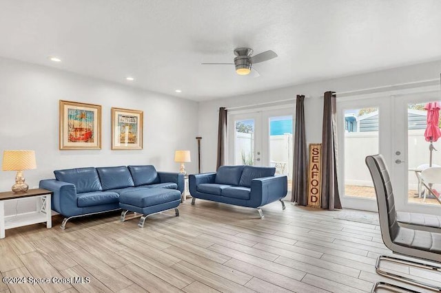 living room with ceiling fan, french doors, and light hardwood / wood-style floors