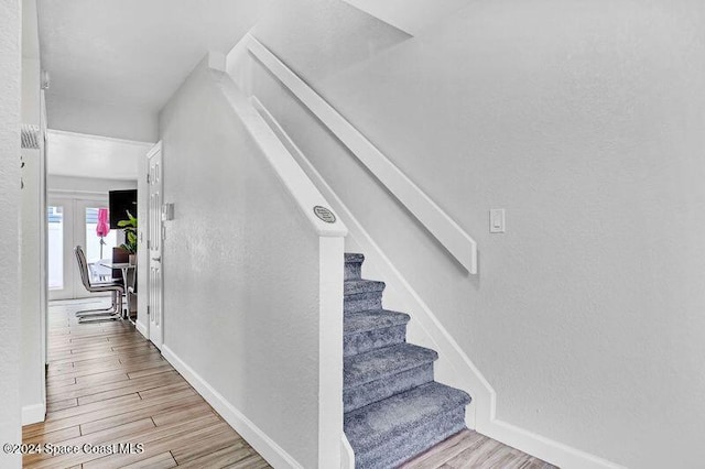 stairs with hardwood / wood-style flooring