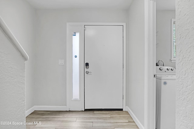 foyer featuring plenty of natural light, light wood-type flooring, and washer / dryer