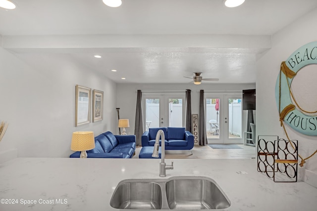 kitchen featuring ceiling fan, sink, and french doors