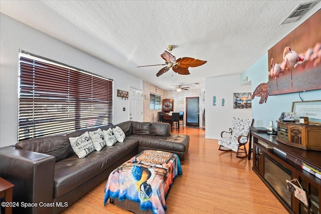 living room with light hardwood / wood-style floors and a textured ceiling