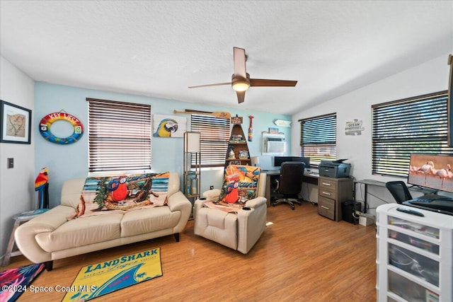 office space with ceiling fan, vaulted ceiling, a textured ceiling, and light hardwood / wood-style flooring