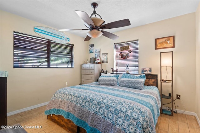 bedroom with ceiling fan and light hardwood / wood-style flooring