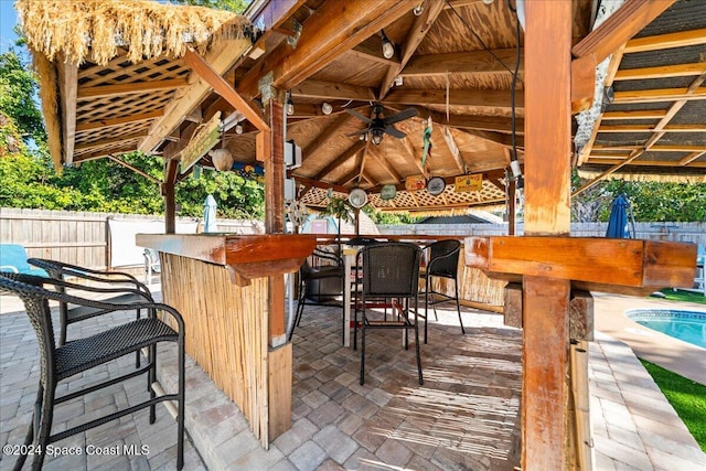 view of patio with a gazebo, a fenced in pool, and exterior bar