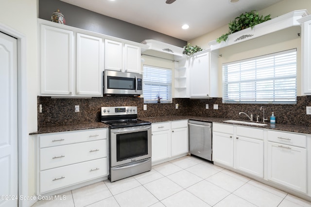 kitchen with white cabinets, backsplash, and appliances with stainless steel finishes