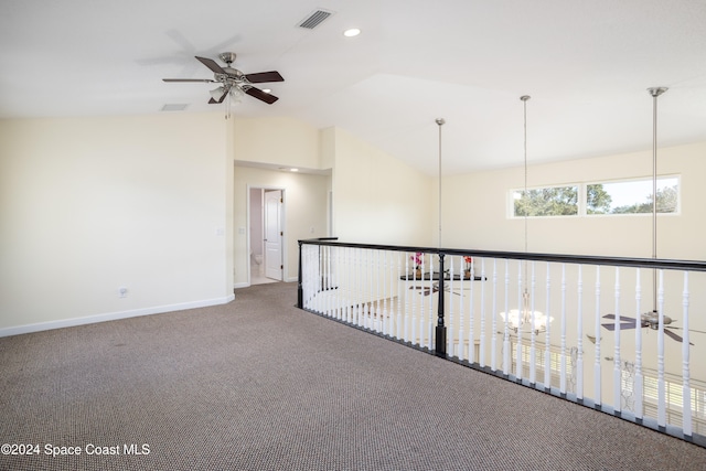 hallway featuring carpet floors and vaulted ceiling