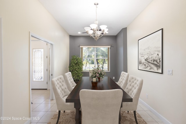 dining area with light tile patterned floors and a notable chandelier