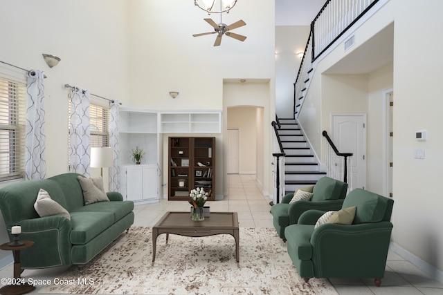 tiled living room featuring a towering ceiling and ceiling fan