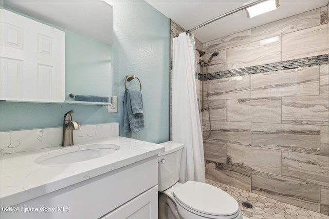 bathroom with vanity, a shower with shower curtain, and toilet