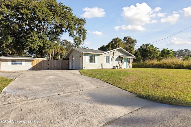 ranch-style home featuring a front yard and a garage