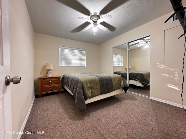 carpeted bedroom with a textured ceiling, a closet, and ceiling fan