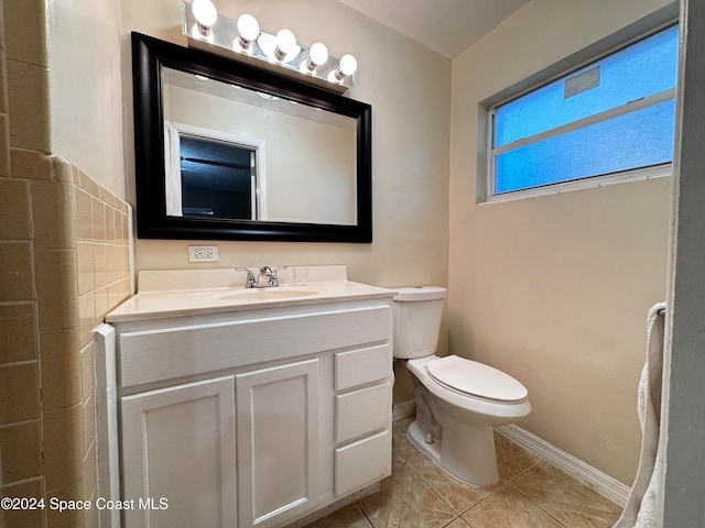 bathroom with tile patterned floors, vanity, and toilet