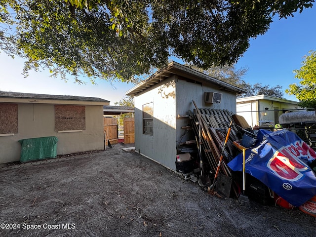 view of side of property with a storage unit