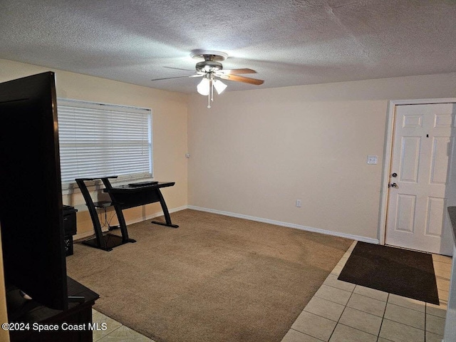 miscellaneous room featuring light carpet, a textured ceiling, and ceiling fan