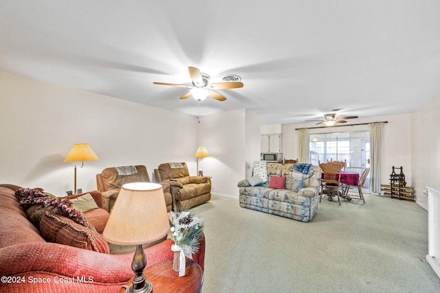 carpeted living room featuring ceiling fan