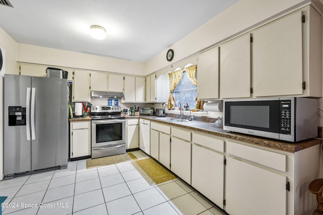 kitchen with sink, light tile patterned floors, and stainless steel appliances