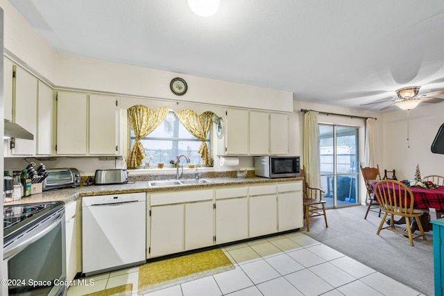 kitchen with stainless steel appliances, extractor fan, ceiling fan, light colored carpet, and sink