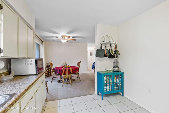 dining room with ceiling fan and light tile patterned flooring