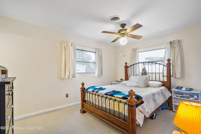 bedroom with carpet flooring, multiple windows, and ceiling fan