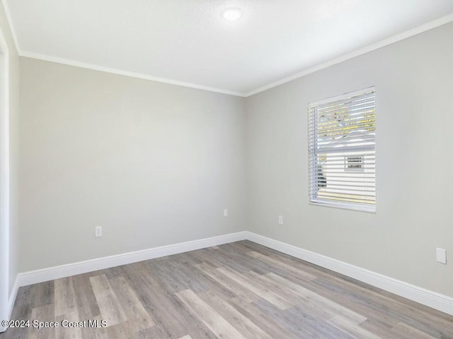 unfurnished room featuring light hardwood / wood-style flooring and crown molding