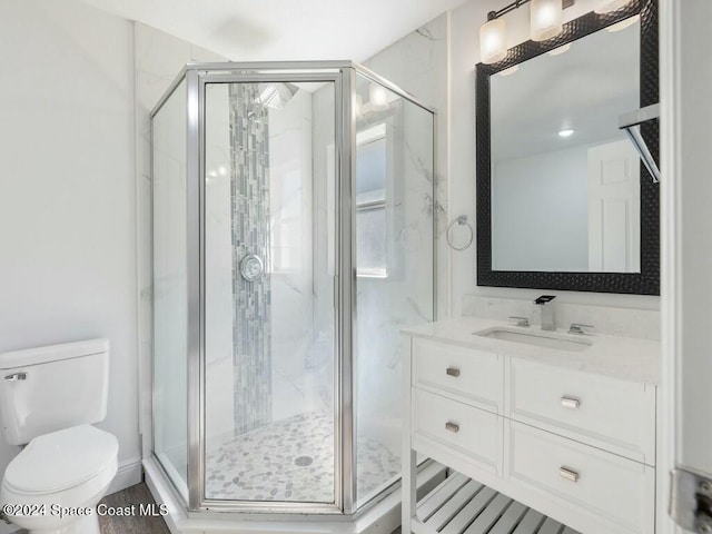 bathroom with vanity, toilet, and walk in shower