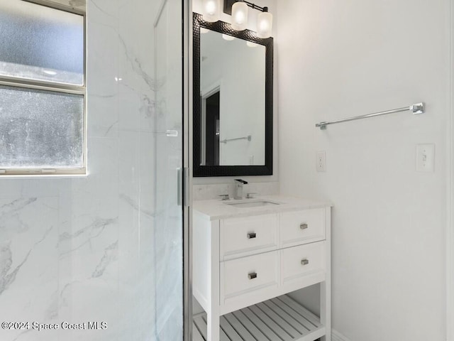 bathroom with vanity and a shower with door