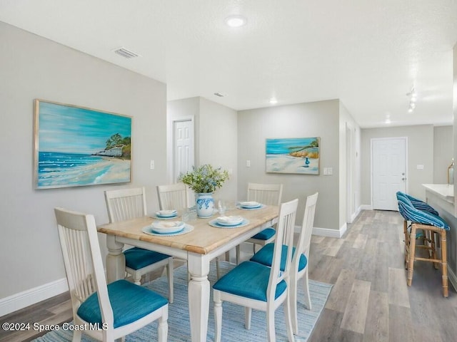 dining area with light hardwood / wood-style flooring