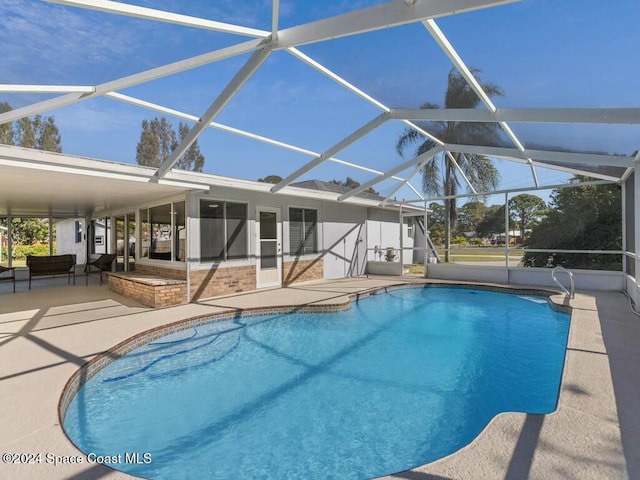 view of swimming pool featuring a lanai and a patio area