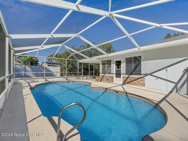 view of pool with a patio and a lanai