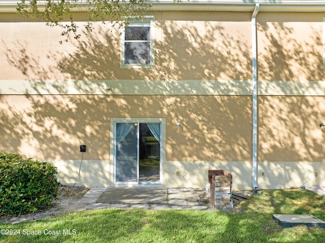 back of property with stucco siding