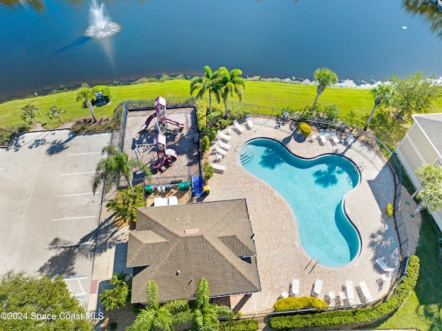 community pool with a patio and fence