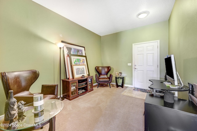 sitting room featuring carpet floors and baseboards