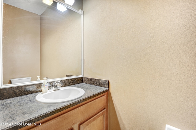 bathroom featuring vanity and toilet