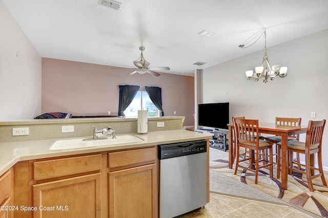 kitchen with stainless steel dishwasher, ceiling fan with notable chandelier, sink, light tile patterned floors, and pendant lighting