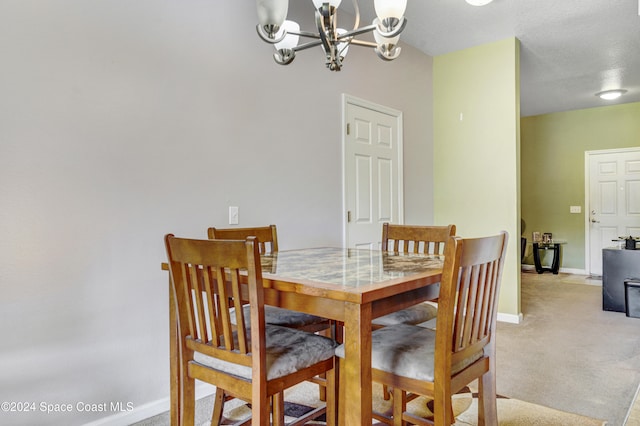 dining space featuring light carpet, an inviting chandelier, and baseboards