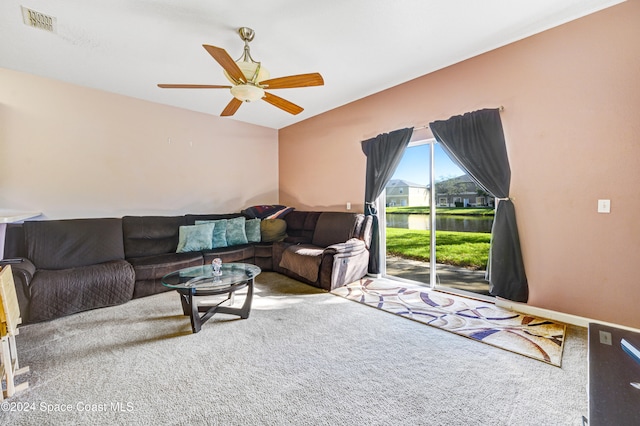 carpeted living area featuring a ceiling fan, visible vents, and baseboards